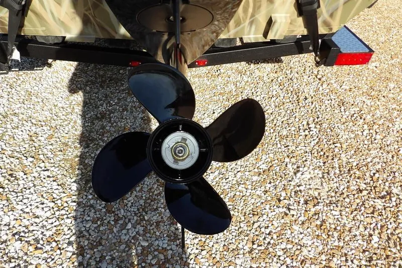 Slide: The Image of Propeller of 2026 Crestliner 1860 Retriever Deluxe on gravel surface. - 32