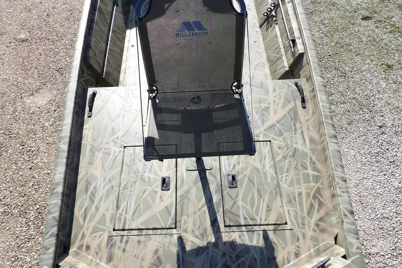 Slide: The Image of 2026 Crestliner 1860 Retriever Deluxe boat with camo design and fishing chair. - 33