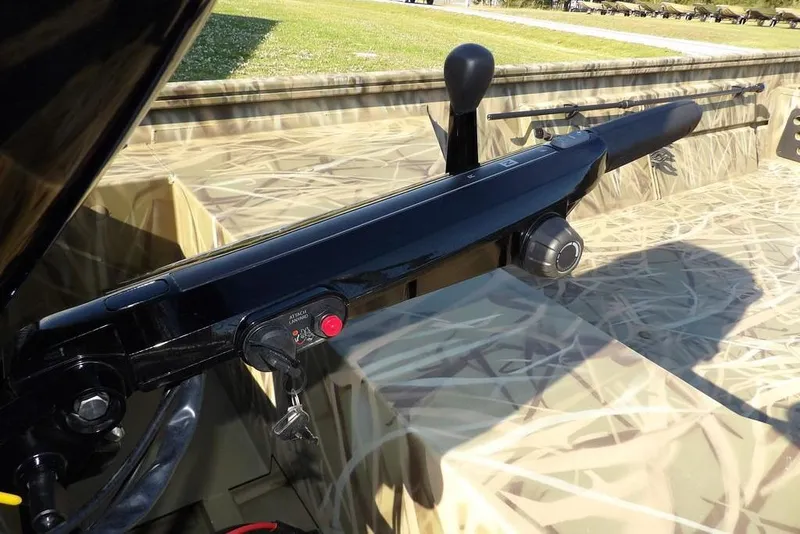 Slide: The Image of 2026 Crestliner 1860 Retriever Deluxe boat interior with camouflage design and trolling motor. - 35