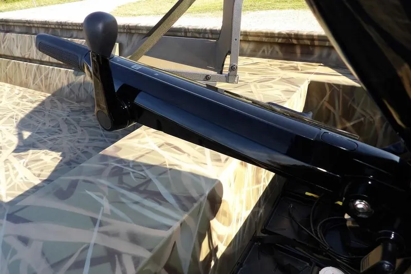 Slide: The Image of 2026 Crestliner 1860 Retriever Deluxe boat with camouflage interior and black handle detail. - 37