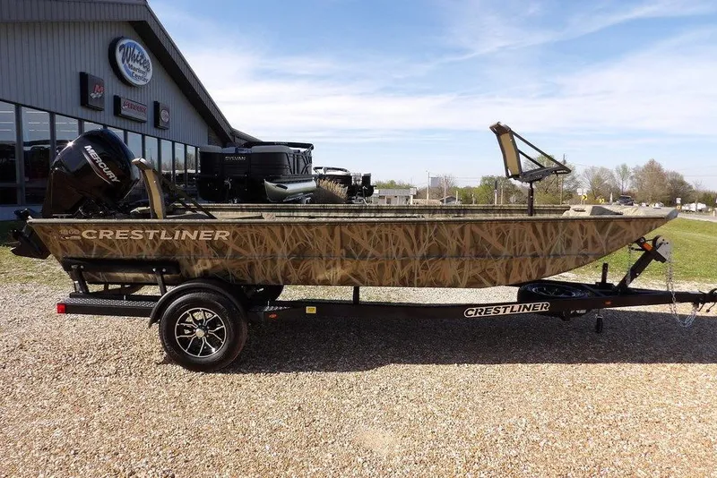 Slide: The Image of 2026 Crestliner 1860 Retriever Deluxe boat with camouflage design on a trailer. - 4