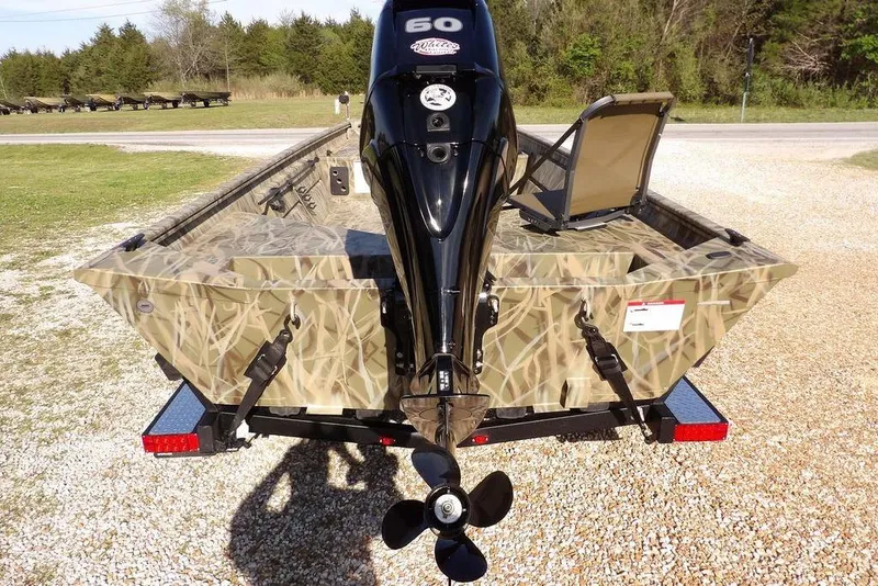 Slide: The Image of 2026 Crestliner 1860 Retriever Deluxe boat with camouflage design and powerful outboard motor. - 7