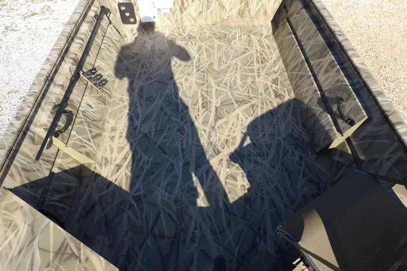 Slide: The Image of Shadow on camo-patterned interior of 2026 Crestliner 1860 Retriever Deluxe boat. - 9