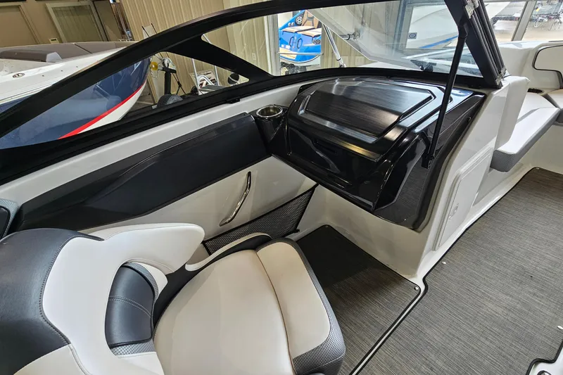 Slide: The Image of Interior of a 2021 Scarab 195 ID boat, featuring sleek seating and modern dashboard design. - 14