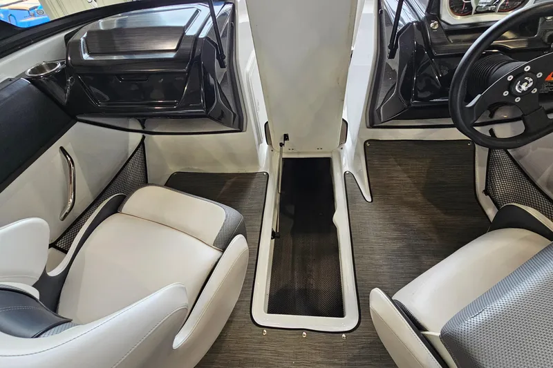 Slide: The Image of Interior of a 2021 Scarab 195 ID boat, featuring modern seating and dashboard design. - 19