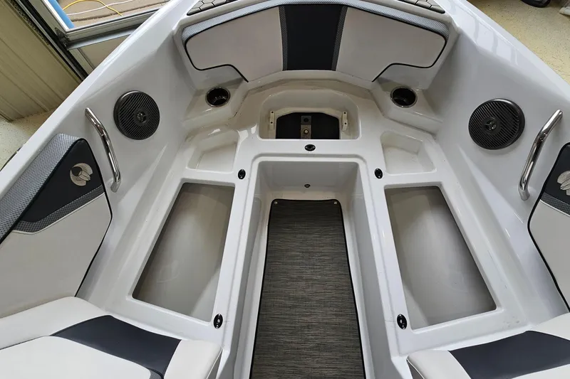 Slide: The Image of Interior of a 2021 Scarab 195 ID boat, featuring seating and storage compartments. - 20