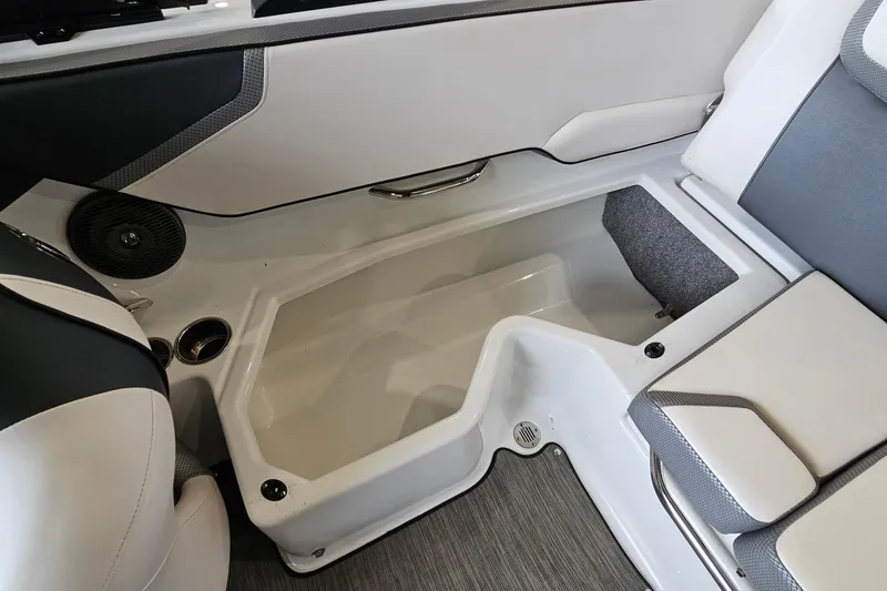 Slide: The Image of Interior storage compartment of 2021 Scarab 195 ID boat, featuring sleek design and seating. - 21