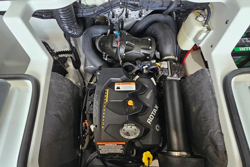 Slide: The Image of Engine compartment of a 2021 Scarab 195 ID boat featuring a Rotax 4-TEC supercharged engine. - 23