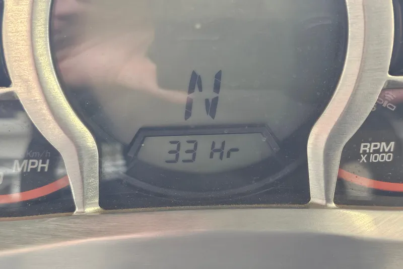 Slide: The Image of Dashboard of 2021 Scarab 195 ID showing 33 hours and speedometer. - 24