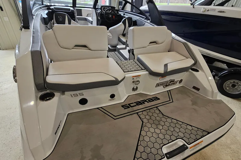 Slide: The Image of 2021 Scarab 195 ID boat interior with white seating and modern design. - 5