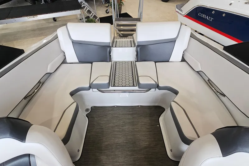 Slide: The Image of Interior seating of 2021 Scarab 195 ID boat, featuring modern white and gray upholstery. - 7