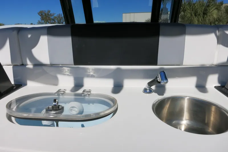 Slide: The Image of 2026 Robalo R270 Center Console boat sink and livewell setup. - 10