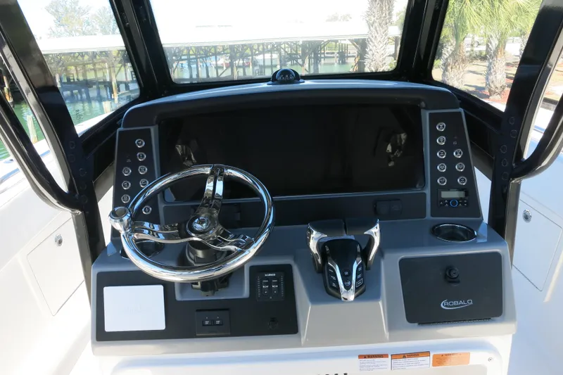 Slide: The Image of 2026 Robalo R270 Center Console helm with modern controls and steering wheel. - 11