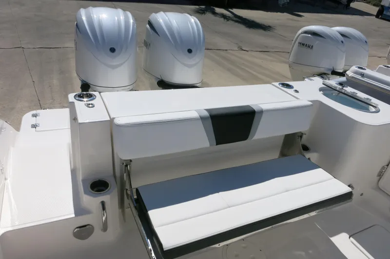 Slide: The Image of 2026 Robalo R270 Center Console boat with Yamaha engines and seating area. - 12