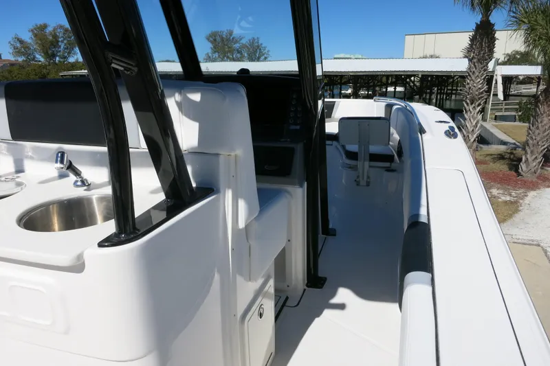 Slide: The Image of 2026 Robalo R270 Center Console boat interior with sink and seating area. - 15