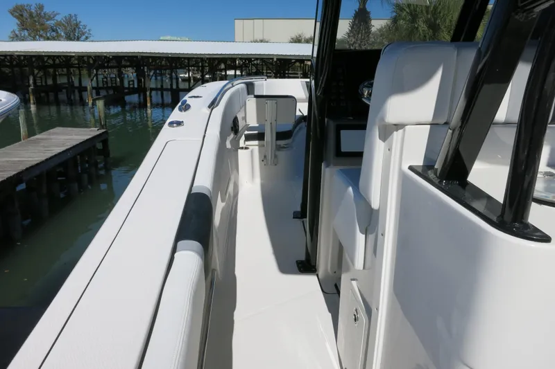Slide: The Image of 2026 Robalo R270 Center Console boat interior, featuring sleek white seating and modern design. - 16