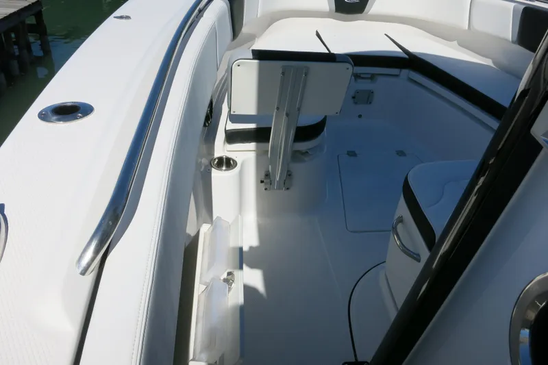 Slide: The Image of 2026 Robalo R270 Center Console boat interior with seating and stainless steel fixtures. - 18