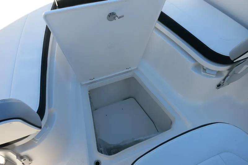 Slide: The Image of 2026 Robalo R270 Center Console boat storage compartment with open lid. - 19