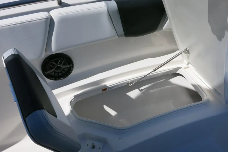 Slide: The Image of 2026 Robalo R270 Center Console boat storage compartment with cushioned seating and speaker. - 21
