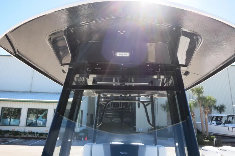 Slide: The Image of 2026 Robalo R270 Center Console boat with sunlit T-top and modern design. - 26