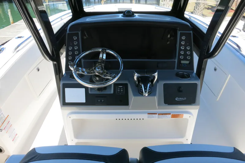 Slide: The Image of 2026 Robalo R270 Center Console helm with modern controls and steering wheel. - 27
