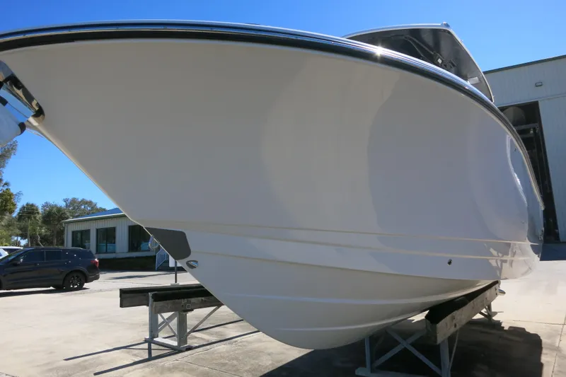 Slide: The Image of 2026 Robalo R270 Center Console boat on display, showcasing sleek hull design. - 6