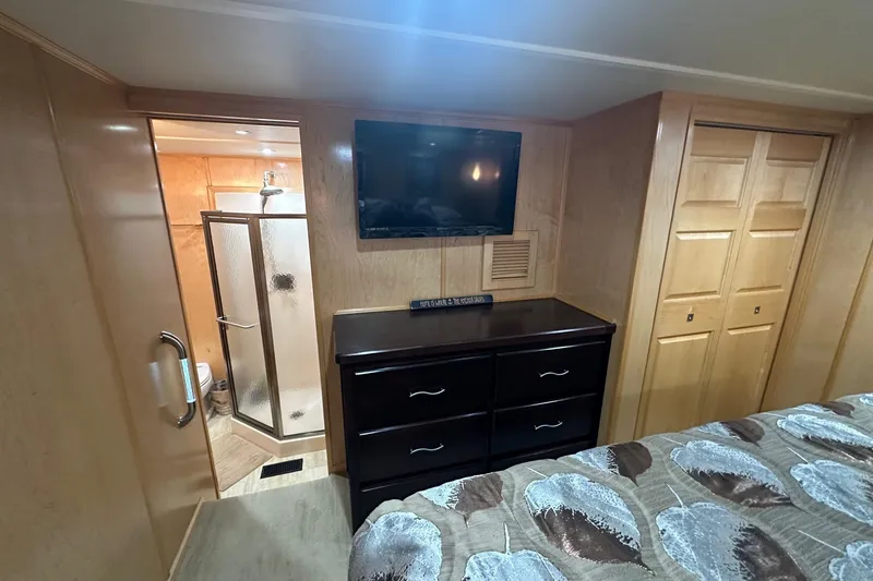 Slide: The Image of Bedroom interior of 2013 Sumerset 18x85 houseboat with TV, dresser, and ensuite bathroom. - 10