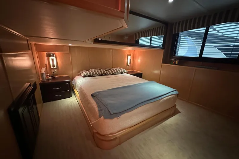 Slide: The Image of Luxurious bedroom interior in a 2013 Sumerset 18x85 houseboat, featuring cozy lighting and modern decor. - 12