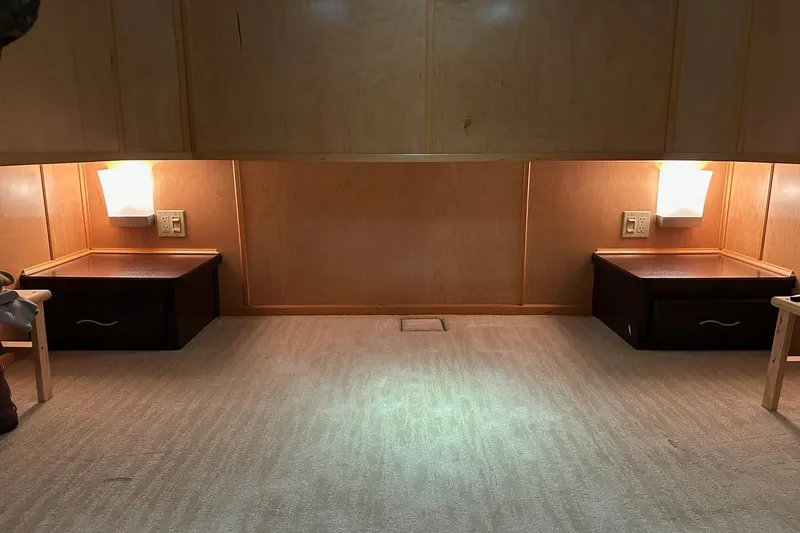 Slide: The Image of Interior of 2013 Sumerset 18x85 houseboat with wood paneling and bedside tables. - 13