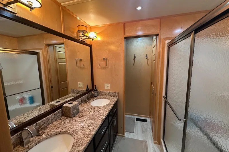 Slide: The Image of Luxurious bathroom in 2013 Sumerset 18x85 houseboat with granite countertops and dual sinks. - 17