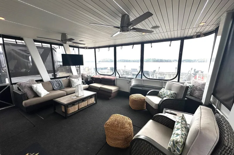 Slide: The Image of Luxurious 2013 Sumerset 18x85 houseboat interior with modern seating and lake view. - 2