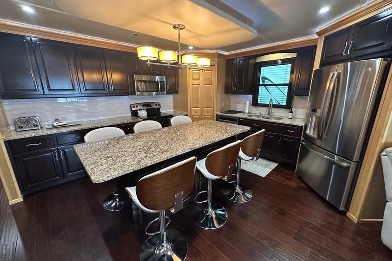 Slide: The Image of Luxurious kitchen in 2013 Sumerset 18x85 houseboat with granite island and modern appliances. - 6