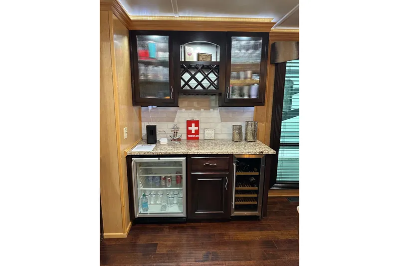 Slide: The Image of Bar area in a 2013 Sumerset 18x85 houseboat with glass cabinets and mini fridge. - 7