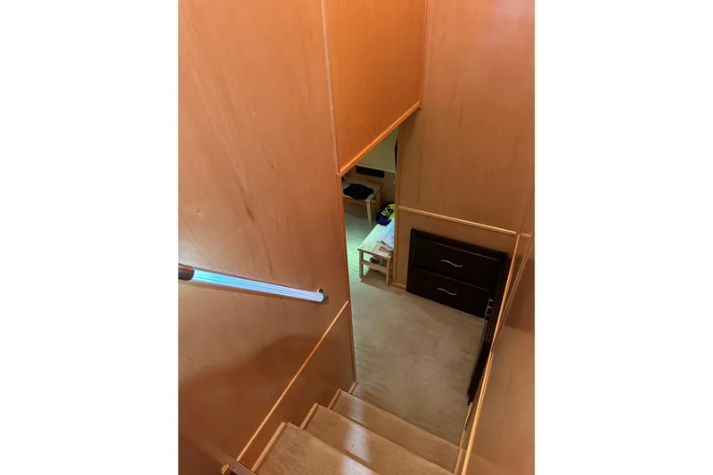 Slide: The Image of Staircase inside 2013 Sumerset 18x85 houseboat, featuring wooden walls and carpeted steps. - 8