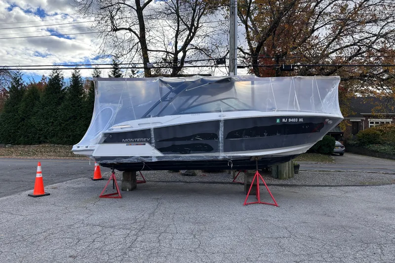 Slide: The Image of 2018 Monterey 258SS Super Sport boat covered and elevated on stands outdoors. - 4