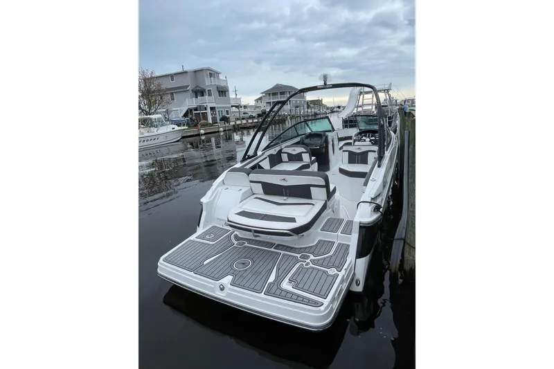 Slide: The Image of 2018 Monterey 258 Super Sport boat docked, featuring sleek design and spacious seating. - 7