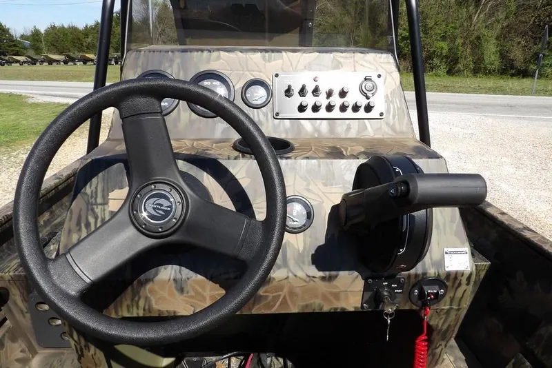 Slide: The Image of 2026 Crestliner 1760 Retriever FCC boat dashboard with steering wheel and control panel. - 11