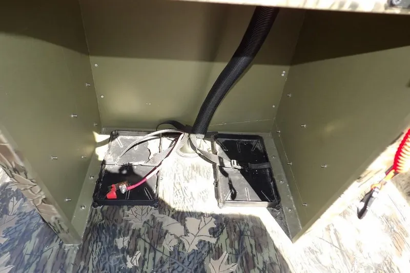 Slide: The Image of Interior view of 2026 Crestliner 1760 Retriever FCC boat's battery compartment. - 14
