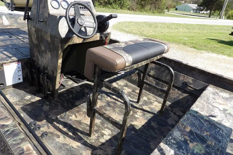 Slide: The Image of 2026 Crestliner 1760 Retriever FCC boat interior with camo design and steering console. - 16