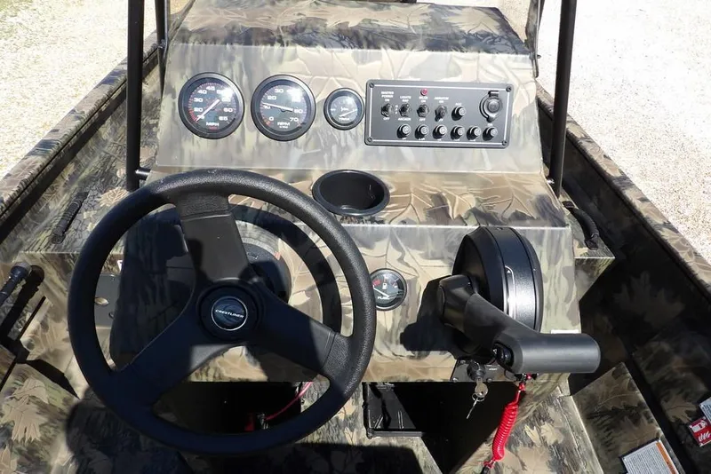 Slide: The Image of 2026 Crestliner 1760 Retriever FCC boat dashboard with camo design and steering wheel. - 17