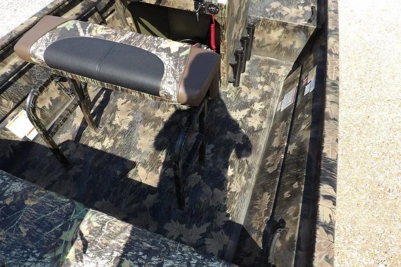 Slide: The Image of 2026 Crestliner 1760 Retriever FCC boat interior with camouflage design and seating. - 18