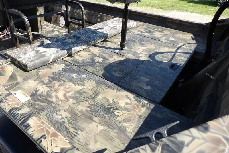 Slide: The Image of 2026 Crestliner 1760 Retriever FCC boat interior with camouflage design and seating. - 19