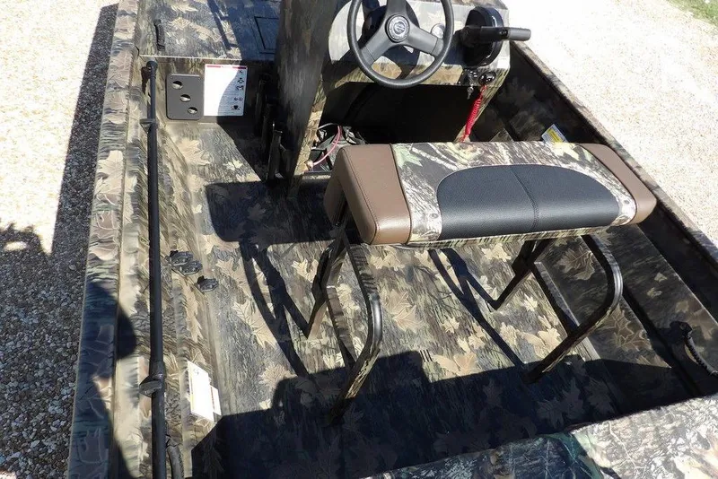 Slide: The Image of 2026 Crestliner 1760 Retriever FCC boat interior with camouflage design and steering console. - 20