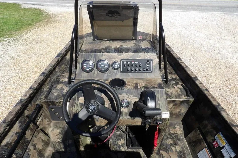 Slide: The Image of 2026 Crestliner 1760 Retriever FCC boat dashboard with camouflage design and control panel. - 28