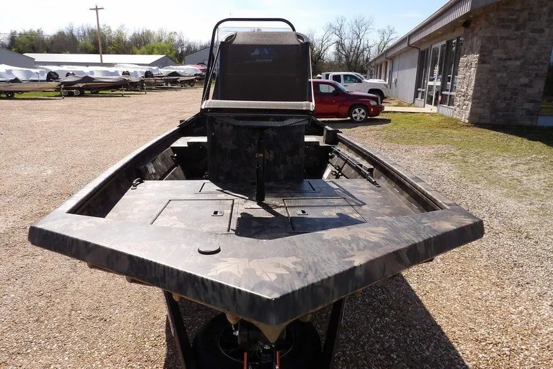 Slide: The Image of 2026 Crestliner 1760 Retriever FCC boat with camouflage design, parked outdoors. - 3