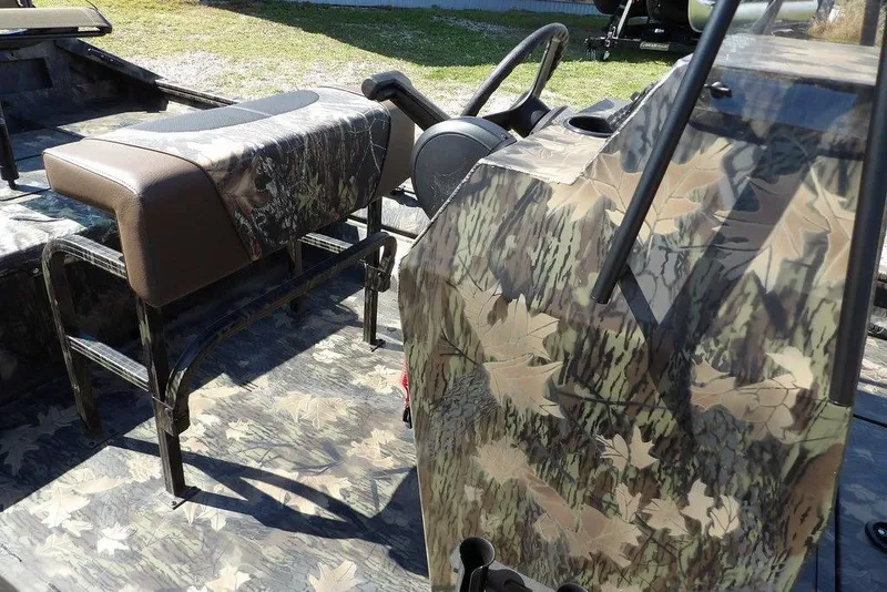 Slide: The Image of 2026 Crestliner 1760 Retriever FCC boat interior with camouflage design and seating. - 30