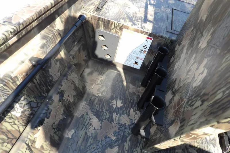 Slide: The Image of 2026 Crestliner 1760 Retriever FCC interior with camouflage design and rod holders. - 31