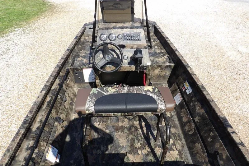 Slide: The Image of 2026 Crestliner 1760 Retriever FCC boat interior with camouflage design and steering console. - 33