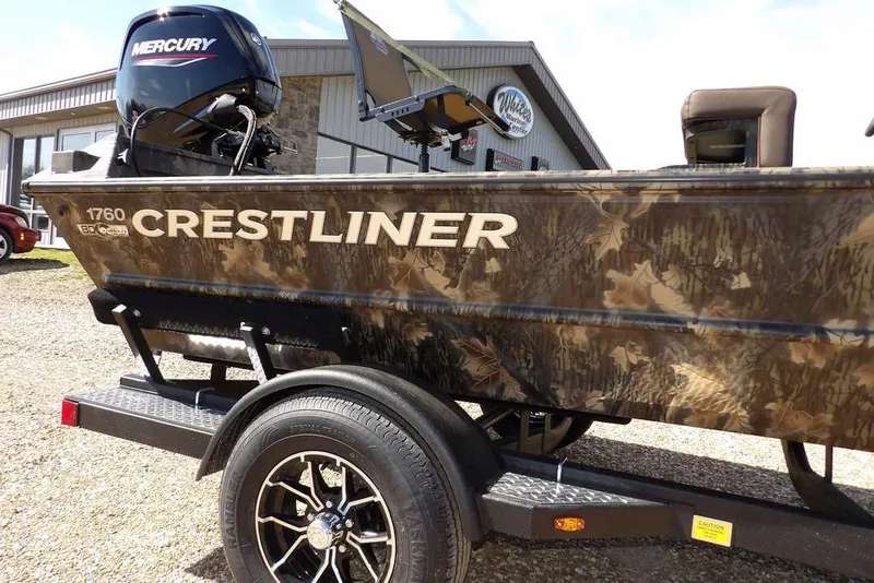 Slide: The Image of 2026 Crestliner 1760 Retriever FCC boat with camouflage design on a trailer. - 34
