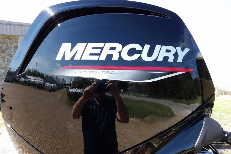 Slide: The Image of Mercury FourStroke engine on 2026 Crestliner 1760 Retriever FCC boat, reflecting outdoor scenery. - 36